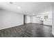 Open concept living and kitchen area with dark gray wood-look tile flooring at 2199 Blue Creek Ct, Conley, GA 30288