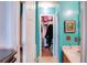 Bathroom with teal walls, walk-in closet, and a sink at 3756 Harvest Dr, Atlanta, GA 30034