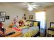 Bedroom with yellow bedding, numerous stuffed animals, and a desk at 3756 Harvest Dr, Atlanta, GA 30034