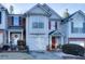 Two-story townhome with gray siding, red door, and attached garage at 3756 Harvest Dr, Atlanta, GA 30034