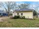 Back exterior of home with yellow siding, a small deck, and a grassy yard at 204 Morris St, Palmetto, GA 30268