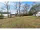 Large backyard with sparse grass, mature trees, and a shed at 204 Morris St, Palmetto, GA 30268