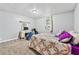 Cozy bedroom with carpet, a ceiling fan, and a comfortable bed with colorful patterned bedding at 204 Morris St, Palmetto, GA 30268