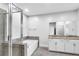 Bright bathroom featuring a tub, frameless shower, and double granite vanity at 4139 Torver Ln, Atlanta, GA 30341