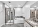 Bright bathroom featuring a shower, tub, and double granite vanity at 4139 Torver Ln, Atlanta, GA 30341