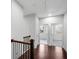 Upstairs hallway featuring hardwood floors, wood railing, and views of the bedroom at 4139 Torver Ln, Atlanta, GA 30341