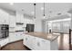 Bright, modern kitchen features white cabinets, granite countertops, stainless appliances and an island at 4139 Torver Ln, Atlanta, GA 30341