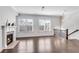 Bright living room showcasing a fireplace, hardwood floors, and staircase to the upper level at 4139 Torver Ln, Atlanta, GA 30341