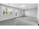Bright living room featuring neutral paint, gray carpet, and a glass door leading to the outside at 4139 Torver Ln, Atlanta, GA 30341