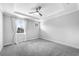 Spacious primary bedroom boasts plush carpet, tray ceiling, ceiling fan, and two windows at 4139 Torver Ln, Atlanta, GA 30341