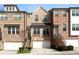 Charming brick townhome featuring a two-car garage, multiple windows and landscaped entryway at 4139 Torver Ln, Atlanta, GA 30341