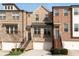 Attractive brick townhome featuring a two-car garage, multiple windows and landscaped entryway at 4139 Torver Ln, Atlanta, GA 30341