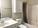 Bathroom with a large white vanity and a shower-tub combination with grey curtain at 517 Mary Margaret Walk, Loganville, GA 30052