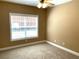 Bedroom boasts a ceiling fan and a large window allowing for plenty of natural light at 517 Mary Margaret Walk, Loganville, GA 30052