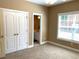 Bedroom features a double door closet and natural light through a window at 517 Mary Margaret Walk, Loganville, GA 30052