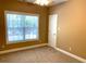 Bedroom with a large window offering natural light and a ceiling fan at 517 Mary Margaret Walk, Loganville, GA 30052