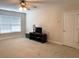 Bonus room features a ceiling fan and window for natural light at 517 Mary Margaret Walk, Loganville, GA 30052