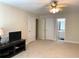 Spacious bonus room with a TV, ceiling fan, and lots of natural light at 517 Mary Margaret Walk, Loganville, GA 30052