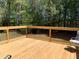 Spacious wooden deck with black metal railings and a view of the lush green backyard at 517 Mary Margaret Walk, Loganville, GA 30052