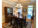 Elegant dining room is furnished with a wooden table and a stylish chandelier, perfect for Gathering meals and gatherings at 517 Mary Margaret Walk, Loganville, GA 30052