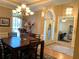 Bright dining area features a wooden table, chandelier, and ample light, providing a cozy space for dining at 517 Mary Margaret Walk, Loganville, GA 30052
