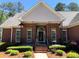 Inviting front porch with brick columns and decorative railing at 517 Mary Margaret Walk, Loganville, GA 30052