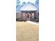 Charming brick home with a cozy front porch and meticulously maintained landscaping leading to the entryway at 517 Mary Margaret Walk, Loganville, GA 30052