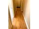 Long, naturally lit hallway featuring beautiful wood floors, and access to multiple rooms at 517 Mary Margaret Walk, Loganville, GA 30052