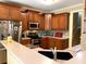 Well-equipped kitchen with stainless steel appliances, wooden cabinets, and a breakfast bar perfect for quick meals at 517 Mary Margaret Walk, Loganville, GA 30052