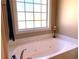 Corner tub with a view in a bright and airy main bathroom at 517 Mary Margaret Walk, Loganville, GA 30052