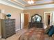 Main bedroom featuring a large dresser, mirror and access to the main bathroom and walk-in closet at 517 Mary Margaret Walk, Loganville, GA 30052
