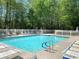 Community pool with lounge chairs and a surrounding fence at 517 Mary Margaret Walk, Loganville, GA 30052