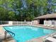 Community pool with lounge chairs and a pool house at 517 Mary Margaret Walk, Loganville, GA 30052