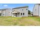 Rear exterior of home with covered patio and lush, green backyard at 722 Crossroad Ct, Powder Springs, GA 30127
