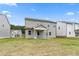 View of the home's back exterior with a covered patio and grassy backyard at 722 Crossroad Ct, Powder Springs, GA 30127