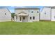 Back exterior of home with covered patio and large backyard at 722 Crossroad Ct, Powder Springs, GA 30127