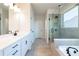 Elegant bathroom with double vanity, soaking tub, and a large walk-in shower at 722 Crossroad Ct, Powder Springs, GA 30127