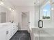 Modern bathroom featuring double vanity, glass shower and soaking tub at 722 Crossroad Ct, Powder Springs, GA 30127