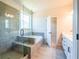 Spa-like bathroom with walk-in shower, soaking tub, and tile flooring at 722 Crossroad Ct, Powder Springs, GA 30127