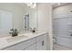 Bright bathroom featuring a double vanity with black hardware and a separate tub and shower at 722 Crossroad Ct, Powder Springs, GA 30127