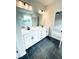 Elegant bathroom with a dual-sink vanity, marble floors, and modern lighting fixtures at 722 Crossroad Ct, Powder Springs, GA 30127