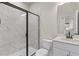 Modern bathroom featuring a glass-enclosed shower with marble tiling and sleek fixtures at 722 Crossroad Ct, Powder Springs, GA 30127