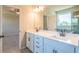 Double vanity bathroom with quartz countertop and a large mirror at 722 Crossroad Ct, Powder Springs, GA 30127