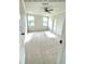 Spacious bedroom featuring upgraded Berber carpet, a ceiling fan, and natural light from two windows at 722 Crossroad Ct, Powder Springs, GA 30127