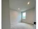 Well-lit bedroom featuring plush carpeting and a window bringing in lots of natural light at 722 Crossroad Ct, Powder Springs, GA 30127
