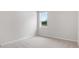 Neutral bedroom with a window providing natural light, carpeted floor, and neutral walls at 722 Crossroad Ct, Powder Springs, GA 30127