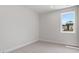 Bright bedroom with neutral carpet, large window, and ample natural light at 722 Crossroad Ct, Powder Springs, GA 30127