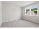Cozy bedroom with neutral carpeting, large windows, and bright natural light at 722 Crossroad Ct, Powder Springs, GA 30127