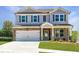 Charming two-story home with stone accents, covered porch, attached two car garage, and well-manicured lawn at 722 Crossroad Ct, Powder Springs, GA 30127