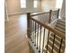 View of a bright foyer with stairs and light wood floors, complemented by a modern black railing system at 722 Crossroad Ct, Powder Springs, GA 30127